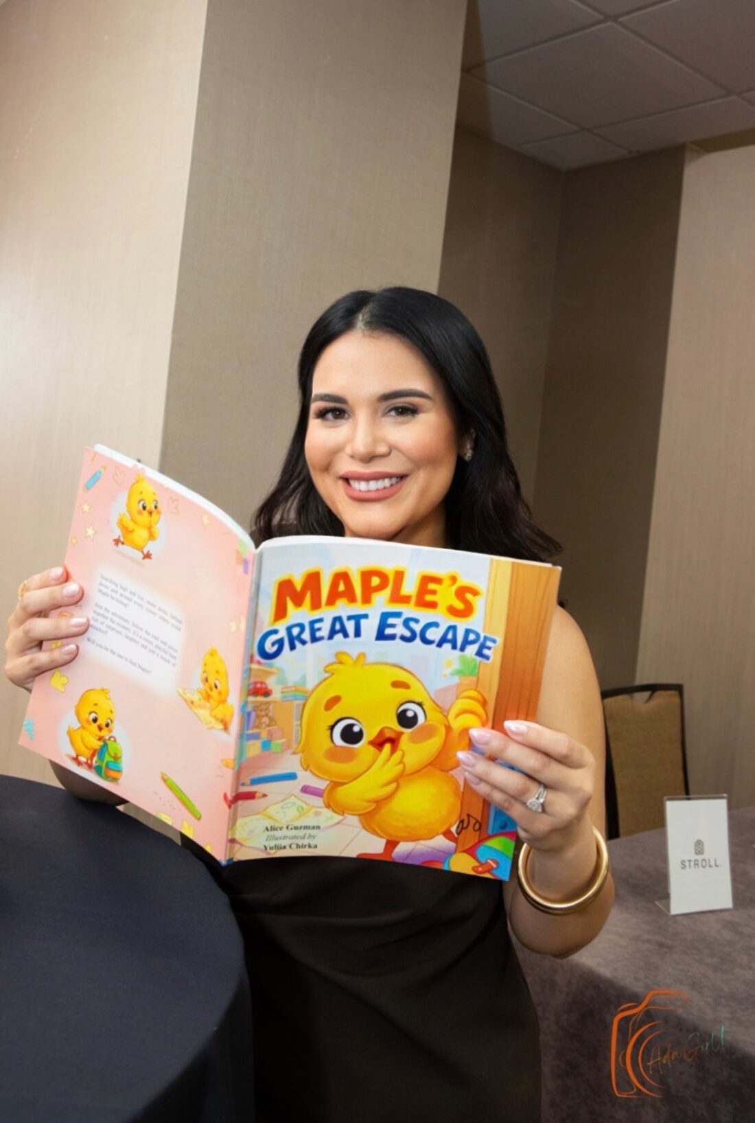 Alice holding Maple's Great Escape at the launch event